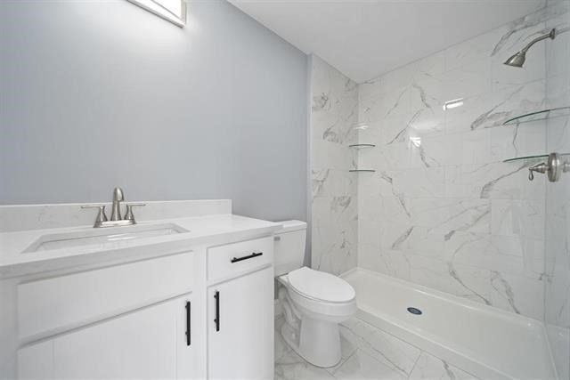 7 Bartons Rdg Road, Unit 7 Greenville, NH 03048 - Photo 14 of 28 a bathroom with a sink a toilet and shower