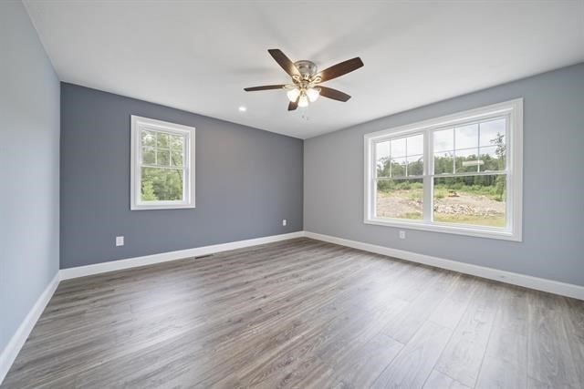 7 Bartons Rdg Road, Unit 7 Greenville, NH 03048 - Photo 15 of 28 a view of an empty room with wooden floor and a window