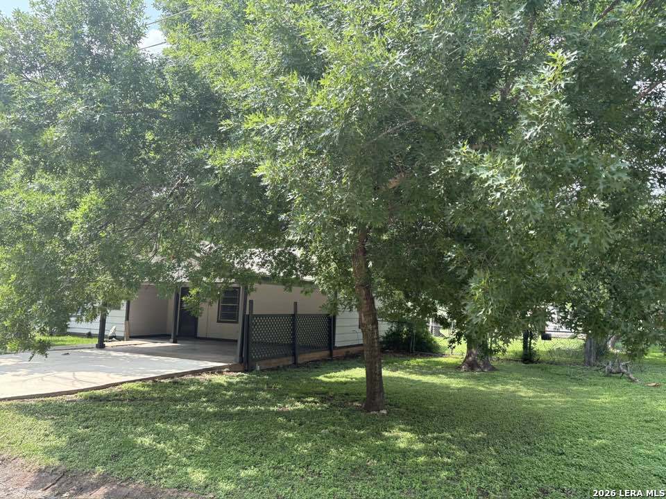 302 Booster Street Center Point, TX 78010 - Photo 2 of 6 a view of a backyard with tree s