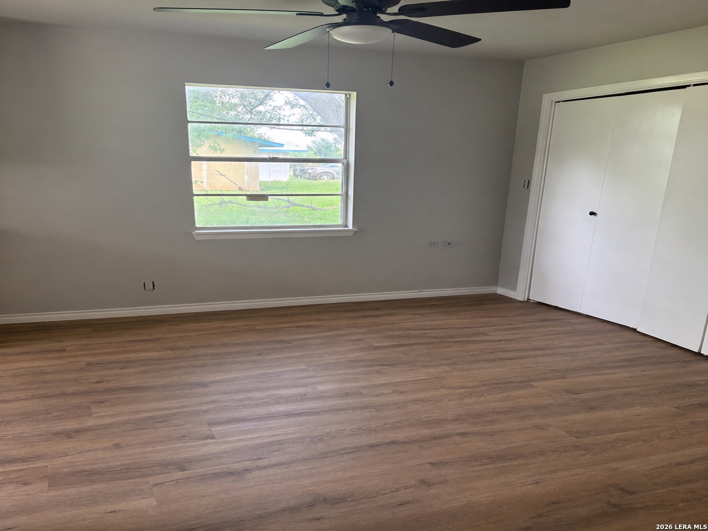 302 Booster Street Center Point, TX 78010 - Photo 5 of 6 wooden floor in an empty room with a window