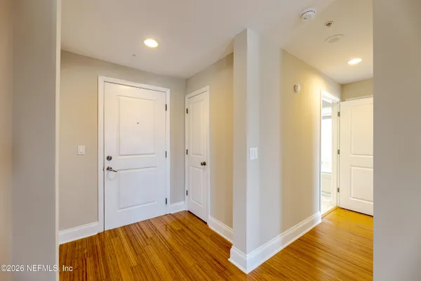 a view of hallway with wooden floor