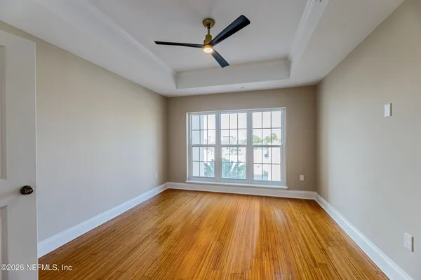 wooden floor in an empty room with a window