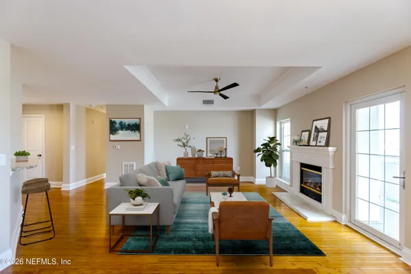 a living room with furniture fireplace and flat screen tv