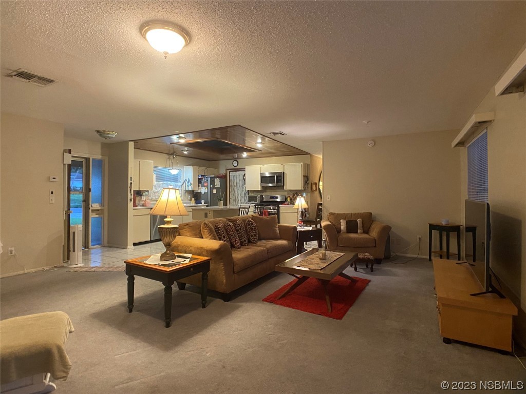 Undisclosed Address Casselberry, FL 32707 - Photo 13 of 19 a living room with furniture and a chandelier