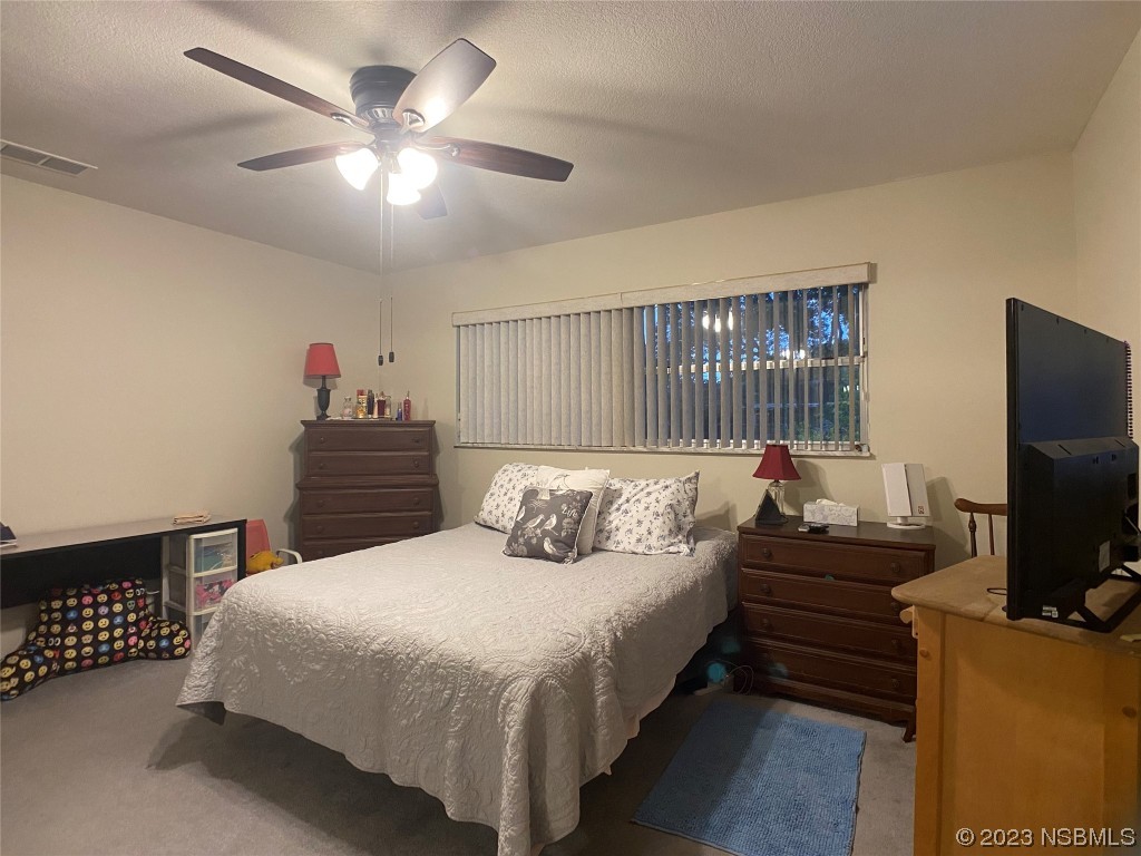 Undisclosed Address Casselberry, FL 32707 - Photo 16 of 19 a bedroom with a bed and a flat screen tv