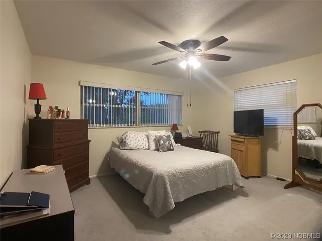 a bedroom with a bed and a television