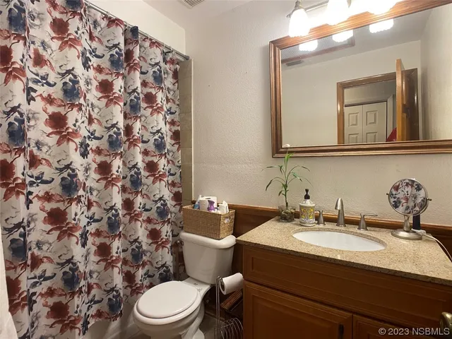 a bathroom with a sink toilet and mirror