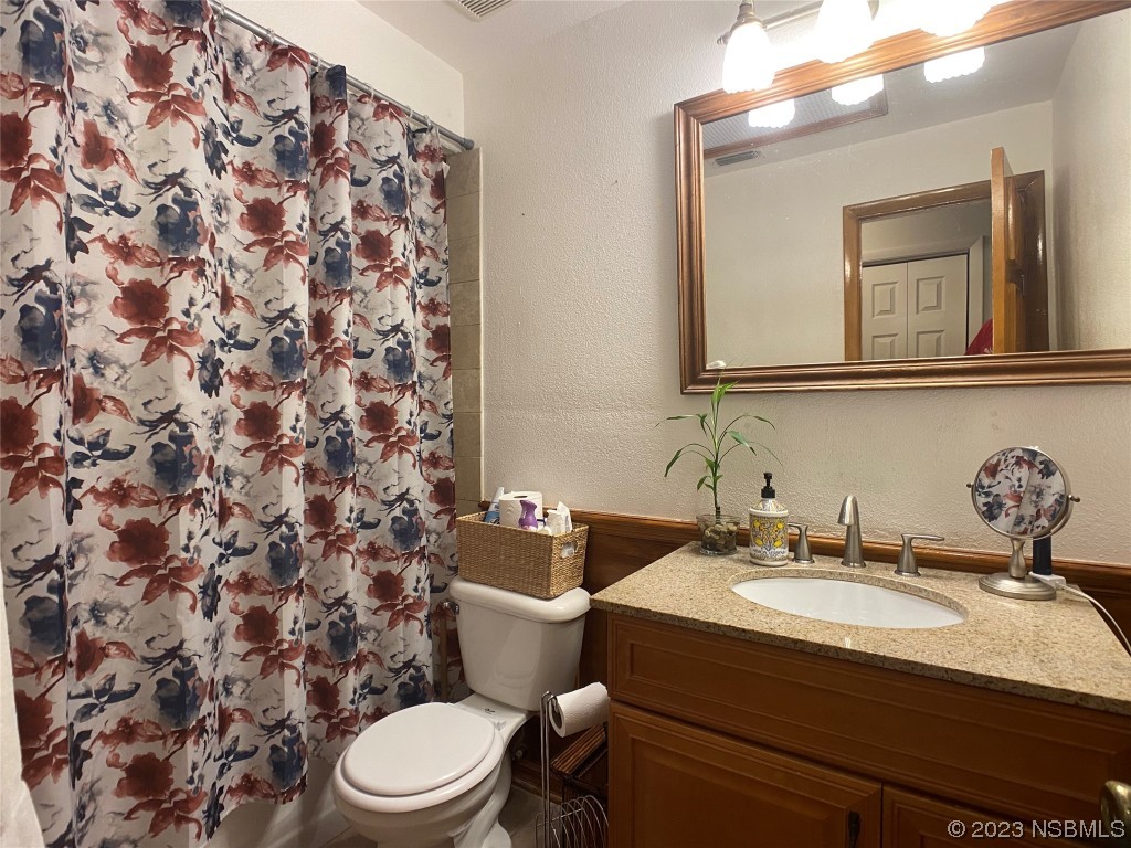 Undisclosed Address Casselberry, FL 32707 - Photo 18 of 19 a bathroom with a sink toilet and mirror
