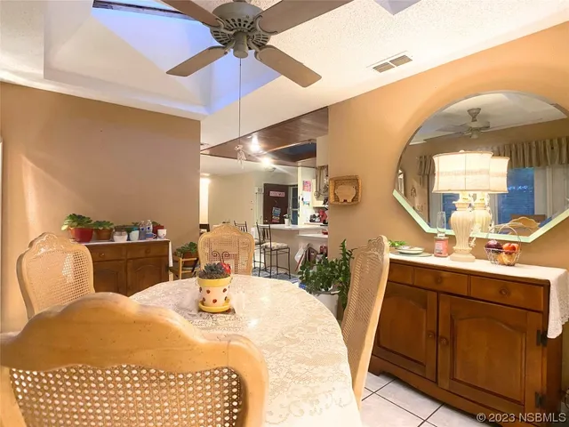 a bedroom with a bed a mirror and lamp