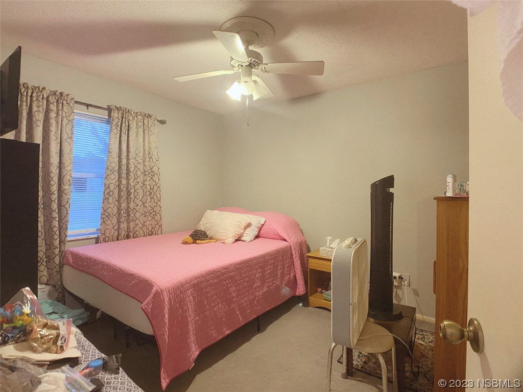 Undisclosed Address Casselberry, FL 32707 - Photo 8 of 19 a bedroom with a bed and a chandelier