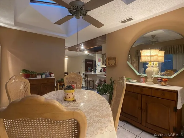 a bedroom with a bed a mirror and lamp