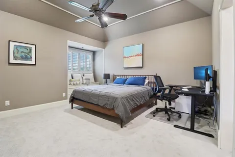 a bedroom with a bed window and a desk