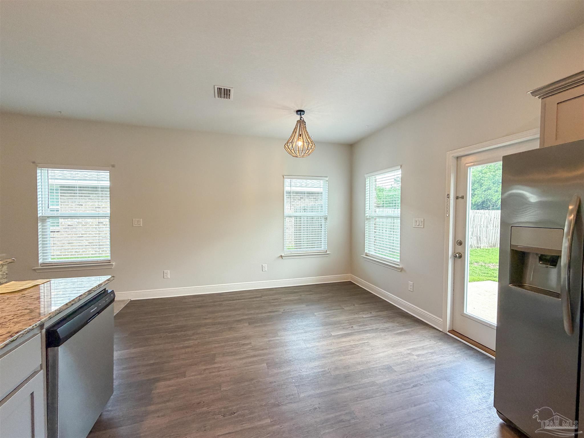 3613 Conley Drive Cantonment, FL 32533 - Photo 8 of 32 a view of an empty room with a window and wooden floor