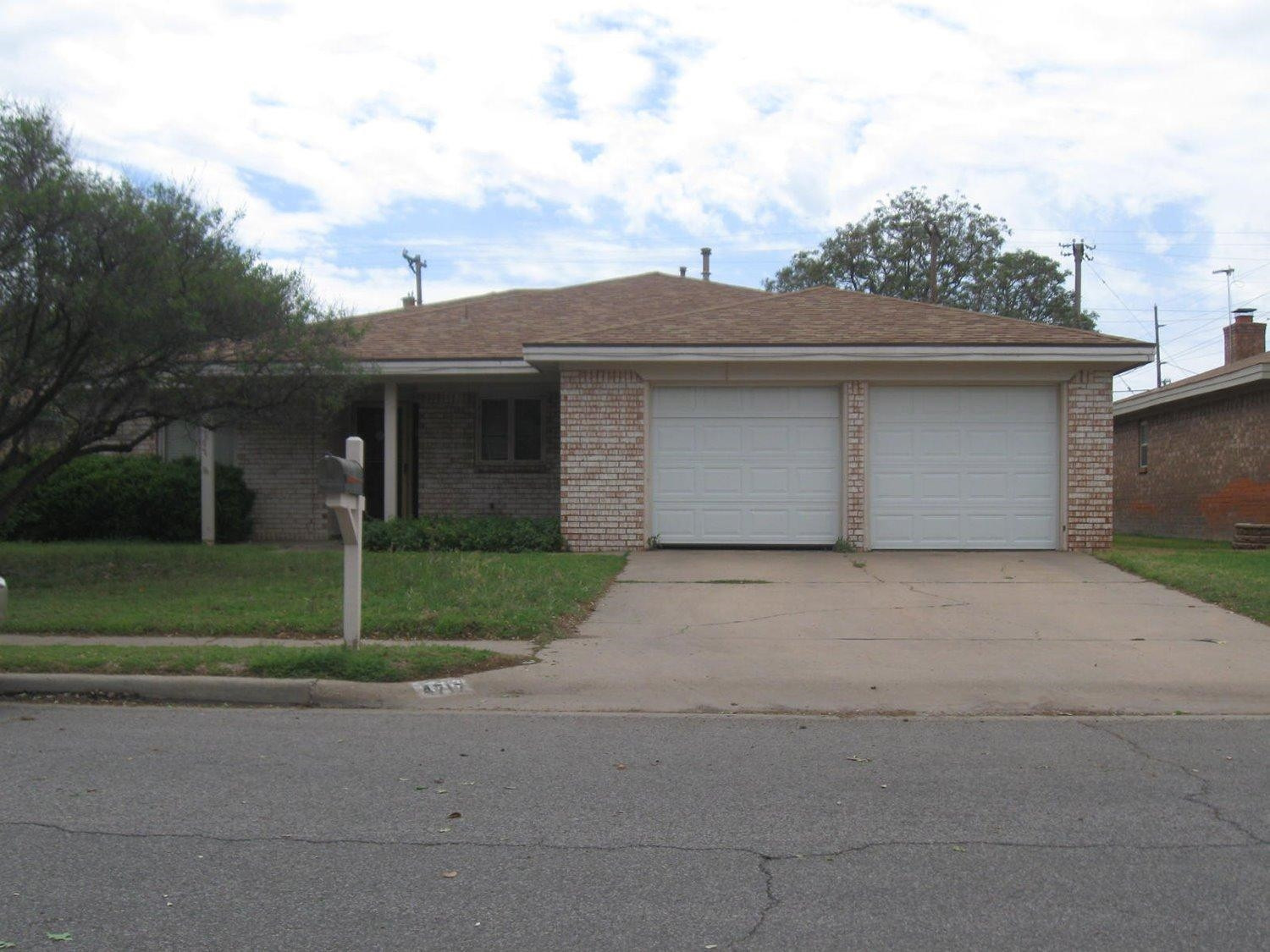 4717 64th Street Lubbock, TX 79414 - Photo 1 of 1 a front view of house with garage and yard