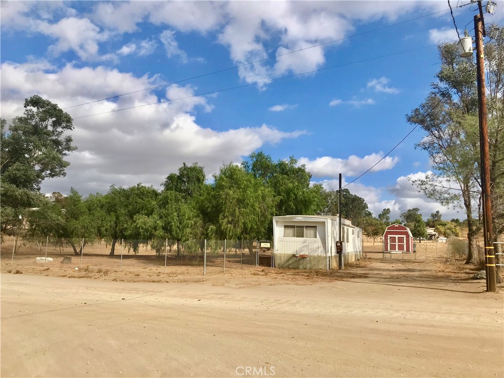 24240 Macfie Road Homeland, CA 92548 - Photo 1 of 1 a view of a house with a snow on the road