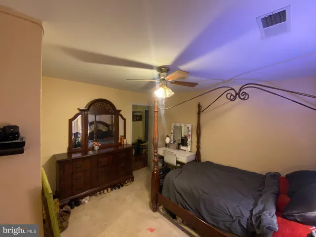 a living room with furniture kitchen view and a flat screen tv