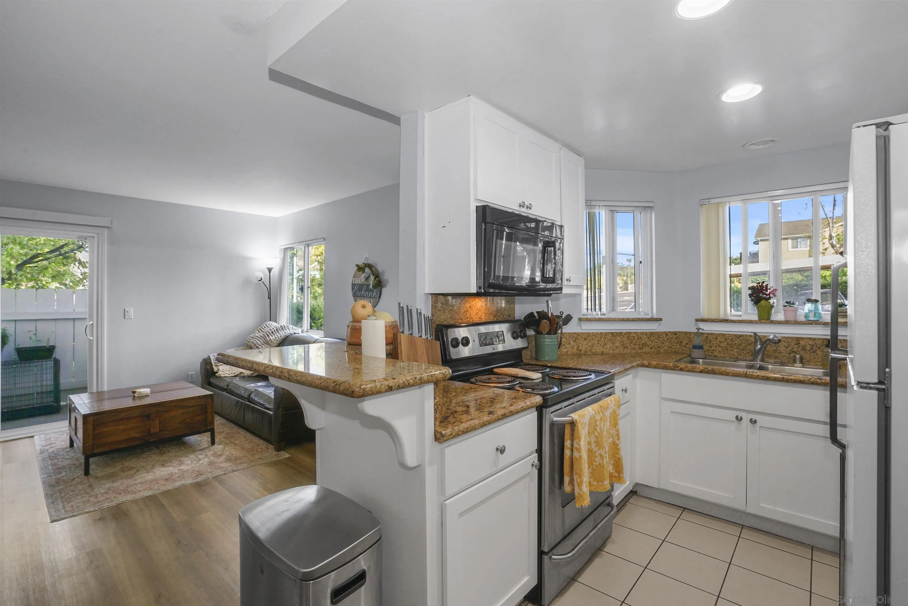 495 San Pasqual Valley Road, Unit 146 Escondido, CA 92025 - Photo 14 of 26 a kitchen with a sink stove and cabinets