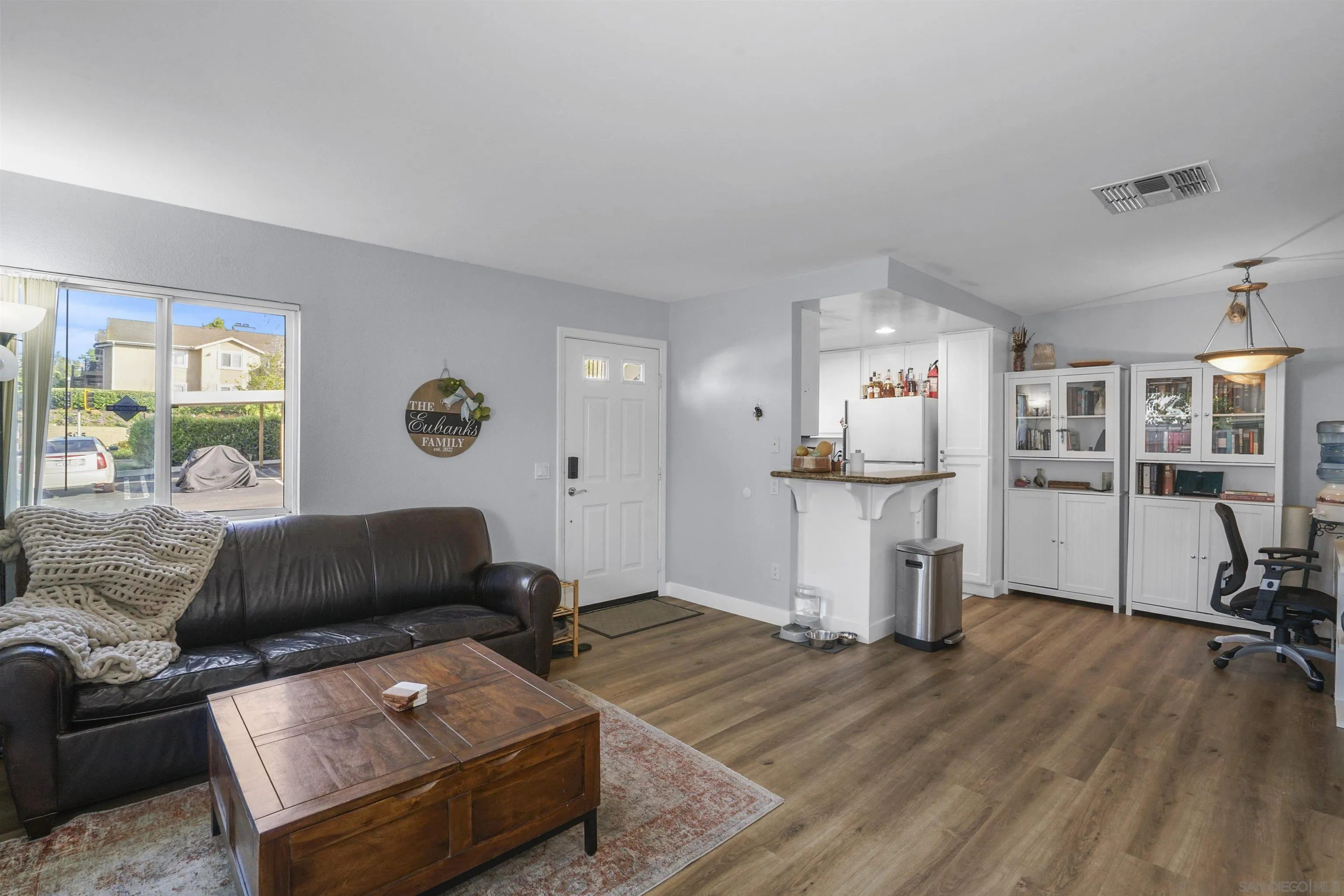 495 San Pasqual Valley Road, Unit 146 Escondido, CA 92025 - Photo 4 of 26 a living room with furniture and a wooden floor