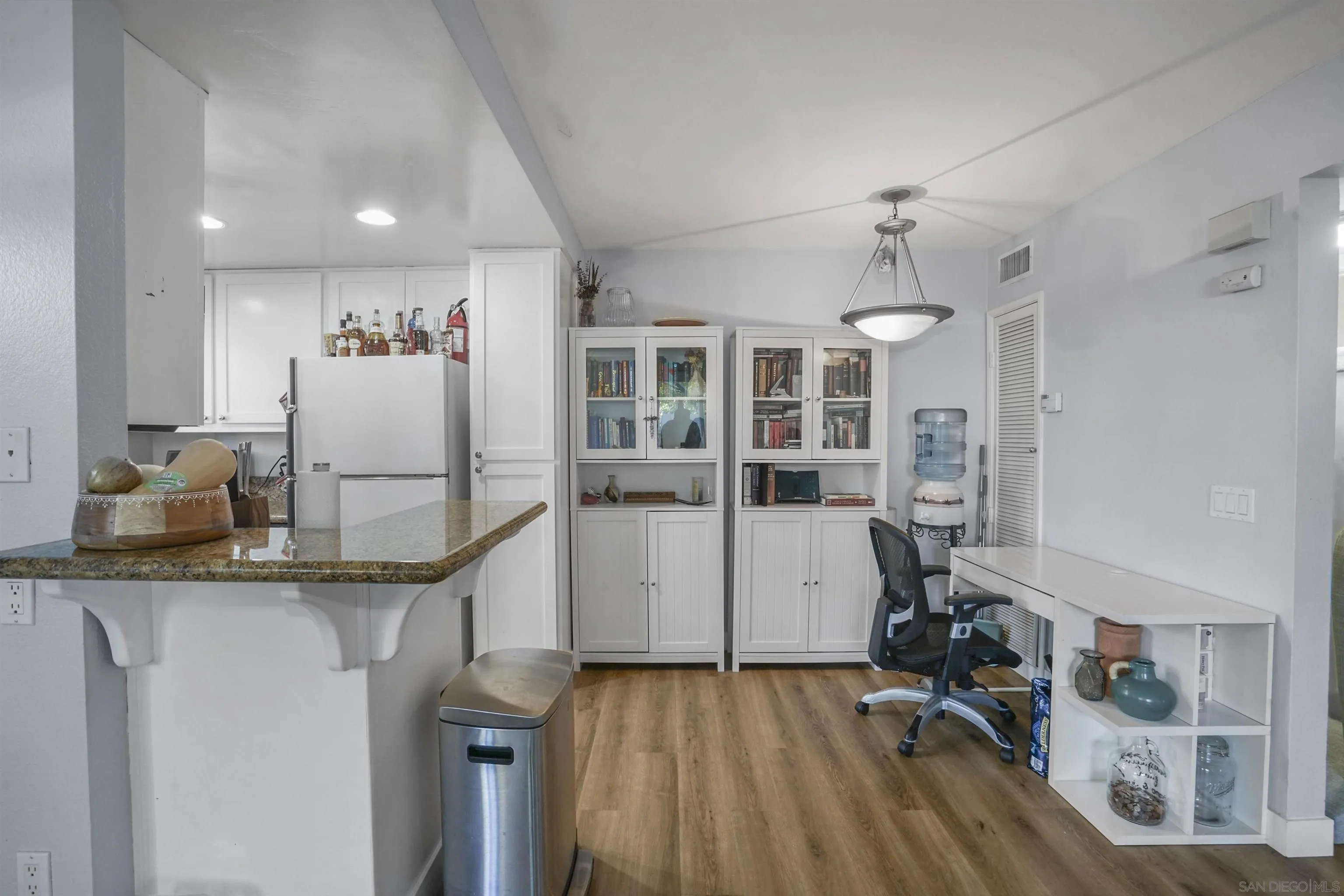 495 San Pasqual Valley Road, Unit 146 Escondido, CA 92025 - Photo 5 of 26 a view of a kitchen with kitchen island stainless steel appliances wooden floor and living room view