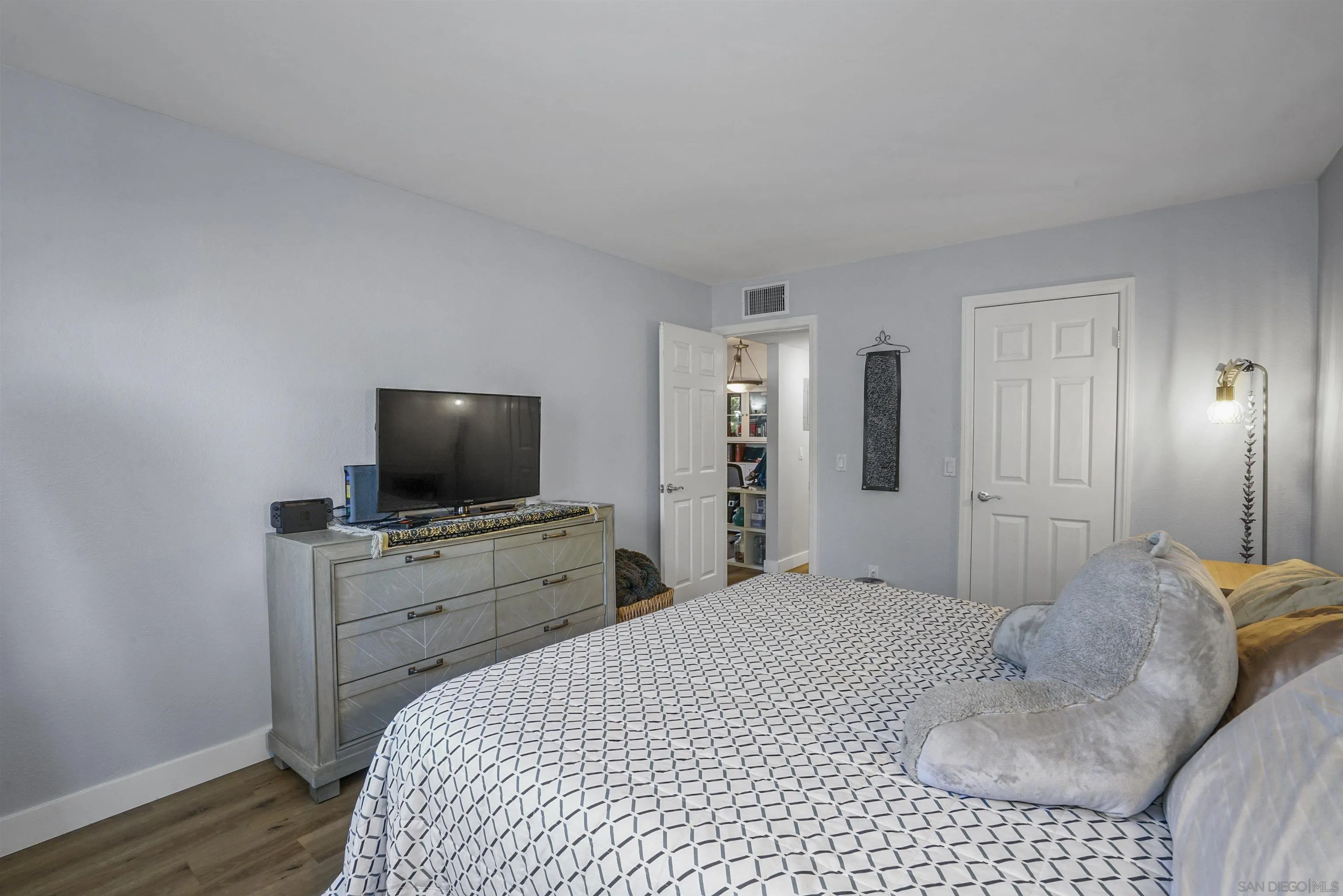 495 San Pasqual Valley Road, Unit 146 Escondido, CA 92025 - Photo 7 of 26 a bedroom with a bed and a television in it