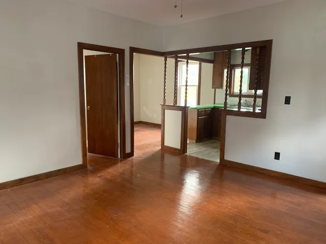 an empty room with windows and closet