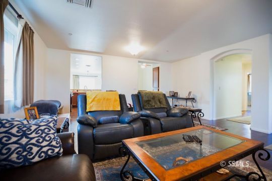 1609 South McCall Street Ridgecrest, CA 93555 - Photo 9 of 33 a living room with furniture and a flat screen tv