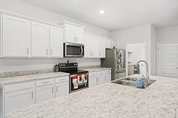 a bathroom with a granite countertop sink a toilet and shower