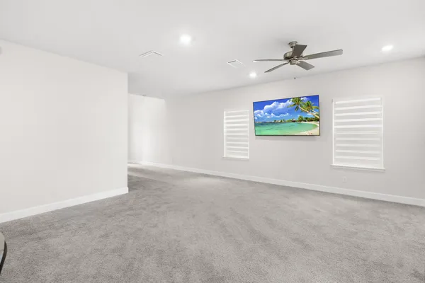a bedroom with a bed and a ceiling fan
