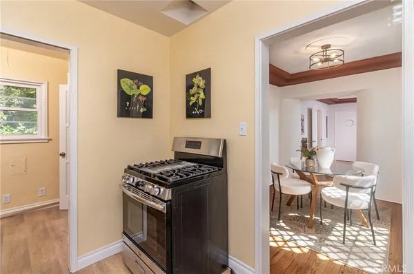 a kitchen with stainless steel appliances a stove a table and a refrigerator