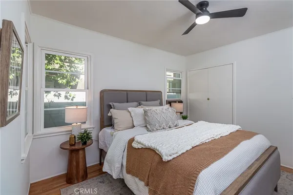 a bedroom with a bed potted plant with the window