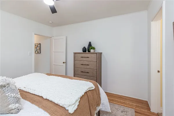 a bedroom with a bed and wooden floor