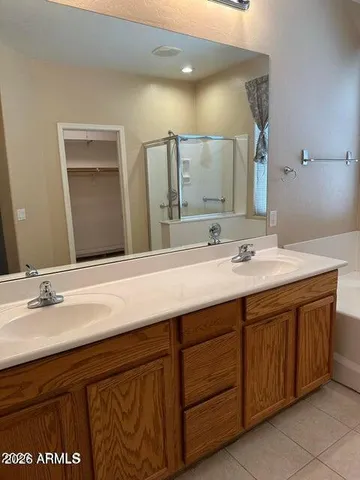 a bathroom with a double vanity sink and a mirror