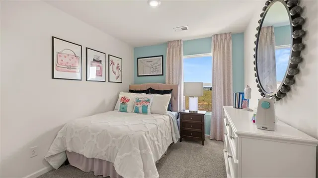 a bedroom with a bed and a painting on the wall