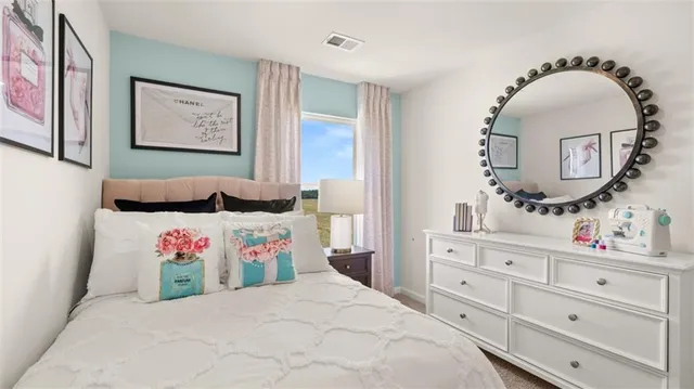 a bedroom with furniture and a mirror