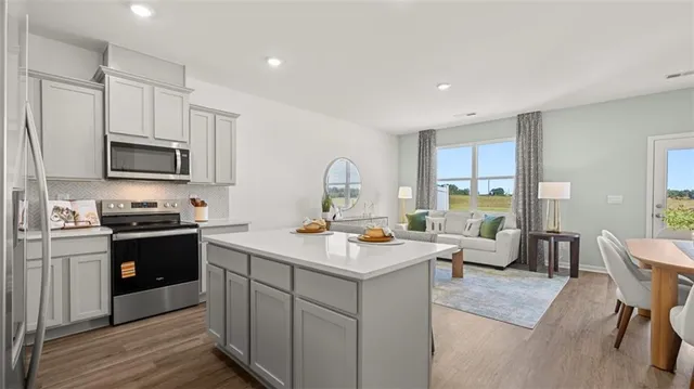 a kitchen with a stove a sink and a refrigerator