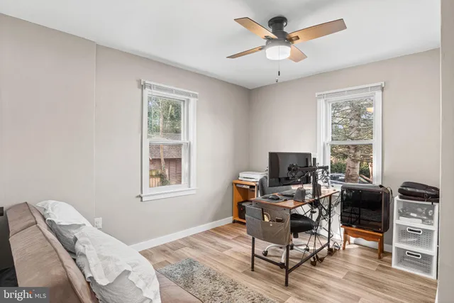 a view of a livingroom with workspace and a window