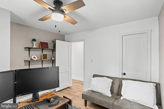 a workspace with furniture and ceiling fan