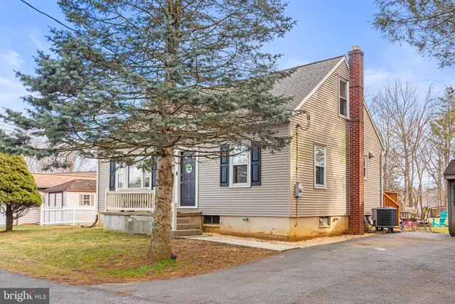 a view of a house with a tree in front of it