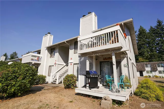 a view of house with porch and furniture