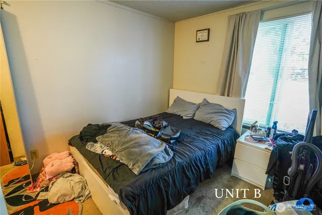 a bedroom with a bed and a mirror