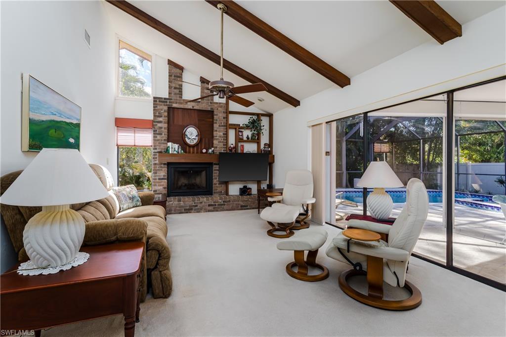 1502 Foxfire Lane Naples, FL 34104 - Photo 12 of 49 a room with furniture and a fireplace
