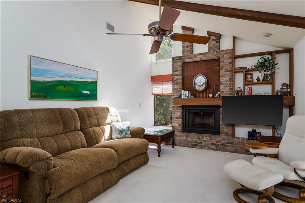 1502 Foxfire Lane Naples, FL 34104 - Photo 13 of 49 a living room with furniture and a fireplace