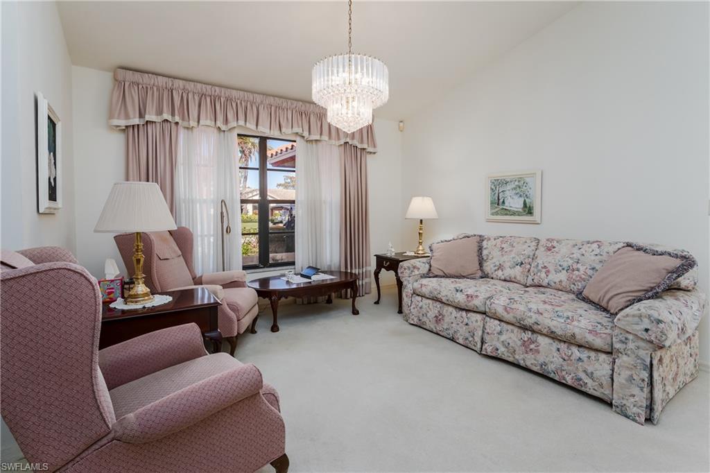 1502 Foxfire Lane Naples, FL 34104 - Photo 15 of 49 a living room with furniture and a chandelier
