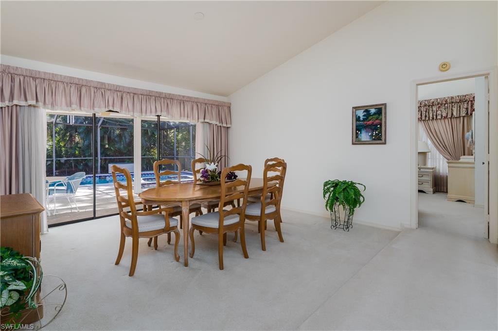 1502 Foxfire Lane Naples, FL 34104 - Photo 17 of 49 a dining room with furniture and a floor to ceiling window