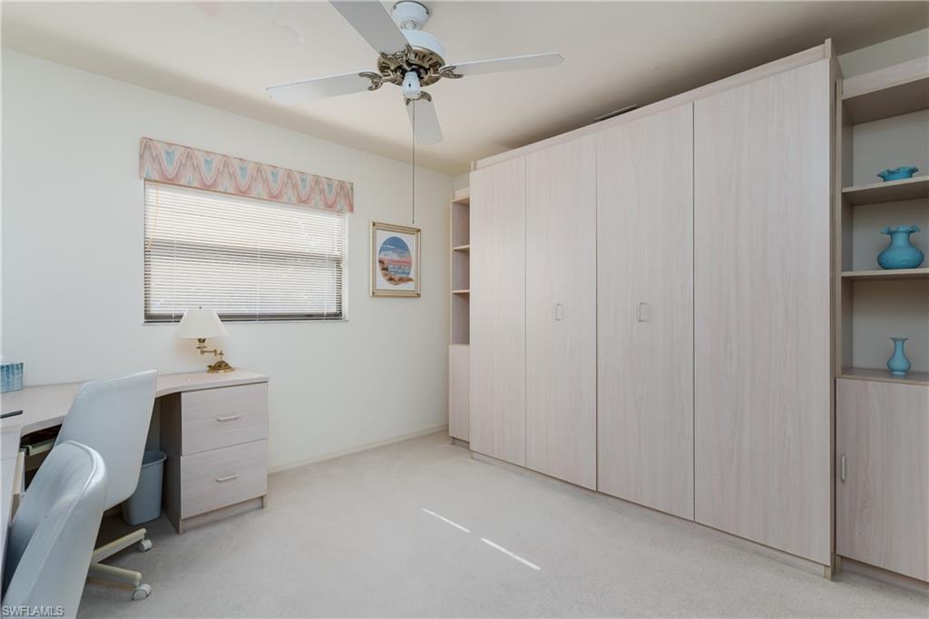 1502 Foxfire Lane Naples, FL 34104 - Photo 25 of 49 a view of a workspace with furniture and a window