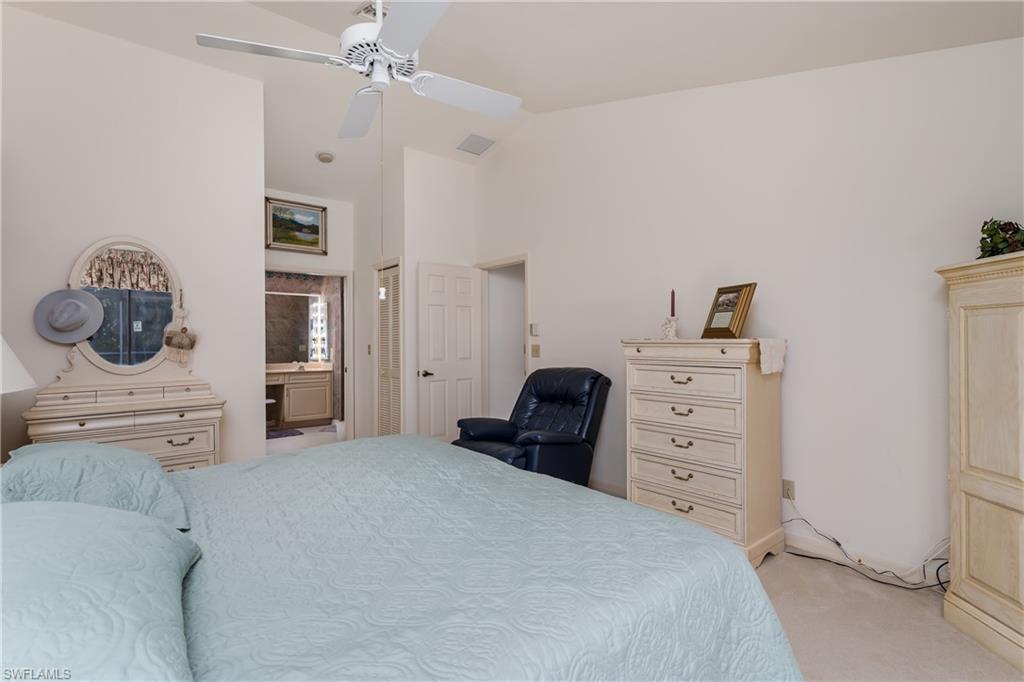 1502 Foxfire Lane Naples, FL 34104 - Photo 28 of 49 a bedroom with a bed and a dresser