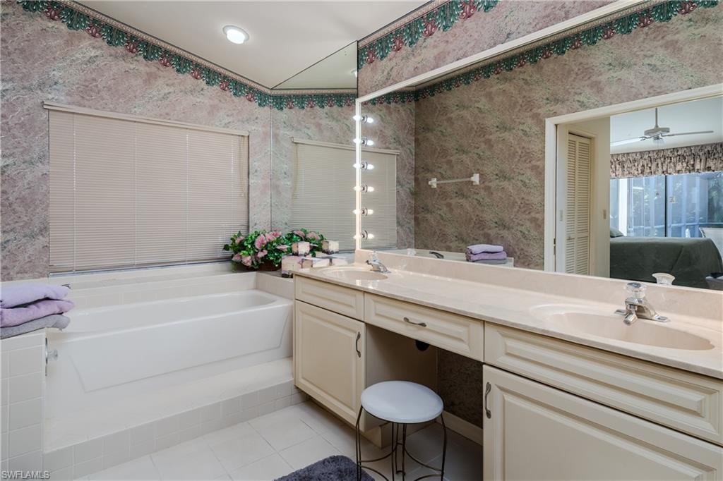 1502 Foxfire Lane Naples, FL 34104 - Photo 31 of 49 a bathroom with a sink and a mirror