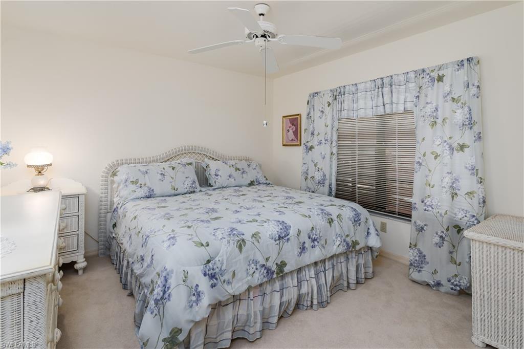 1502 Foxfire Lane Naples, FL 34104 - Photo 32 of 49 a bedroom with a bed and a window