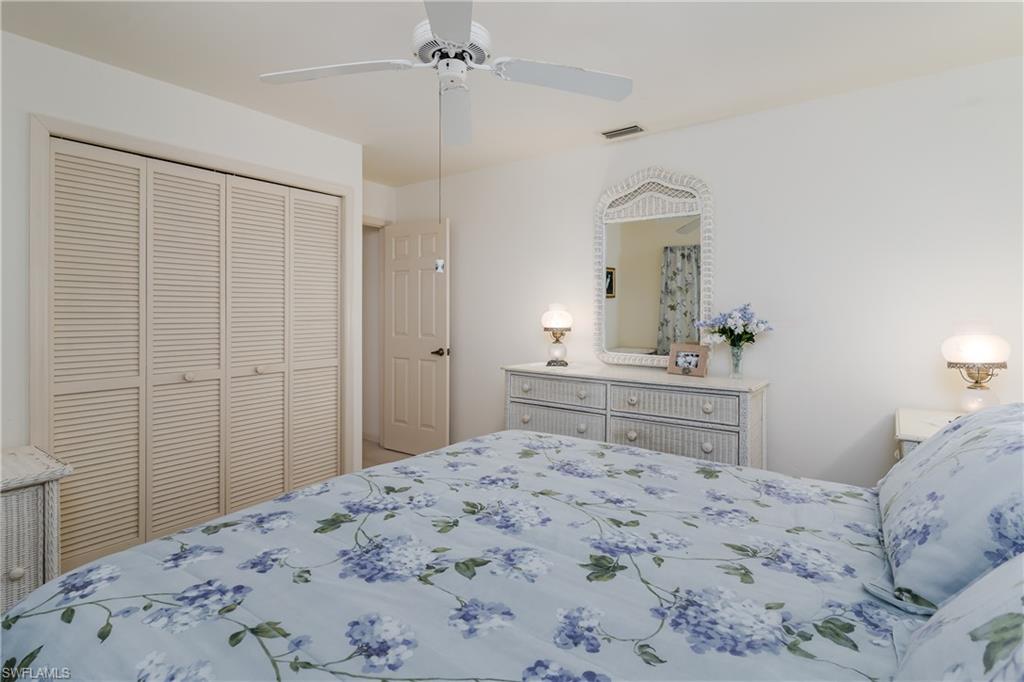 1502 Foxfire Lane Naples, FL 34104 - Photo 33 of 49 a bedroom with a bed and a dresser in it