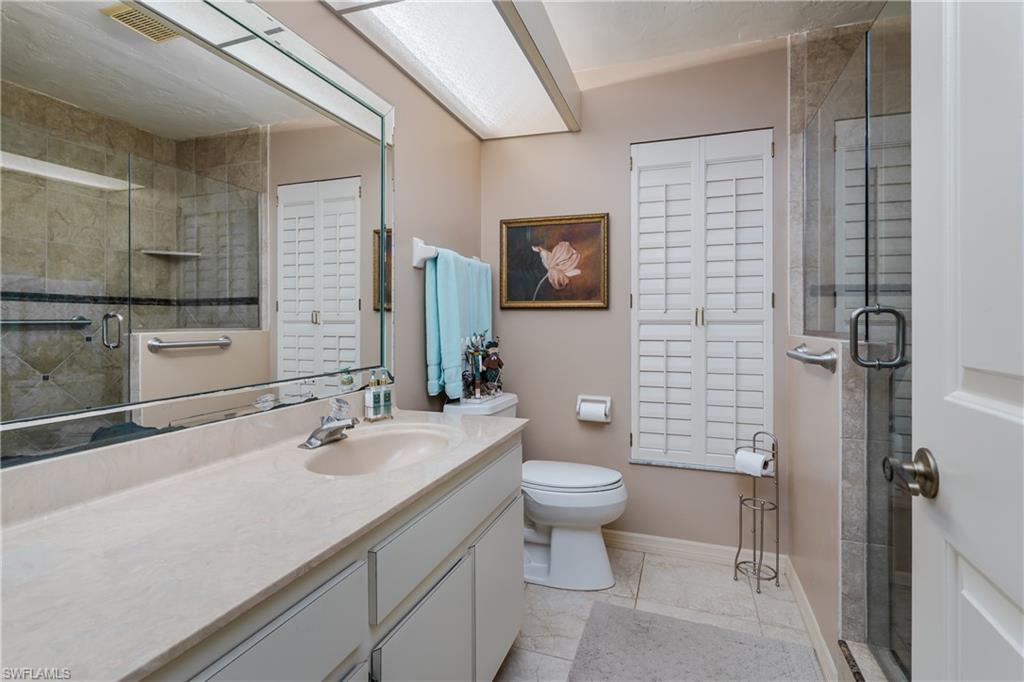 1502 Foxfire Lane Naples, FL 34104 - Photo 34 of 49 a bathroom with a sink a toilet and shower